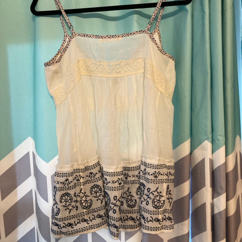 tank top  ,size : medium , colors , baby pink , white and navy blue